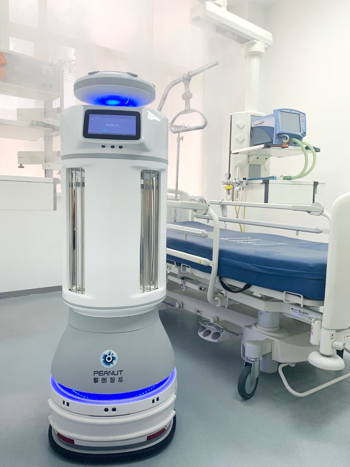 M2 emitting dry mist beside a bed in a hospital ward
